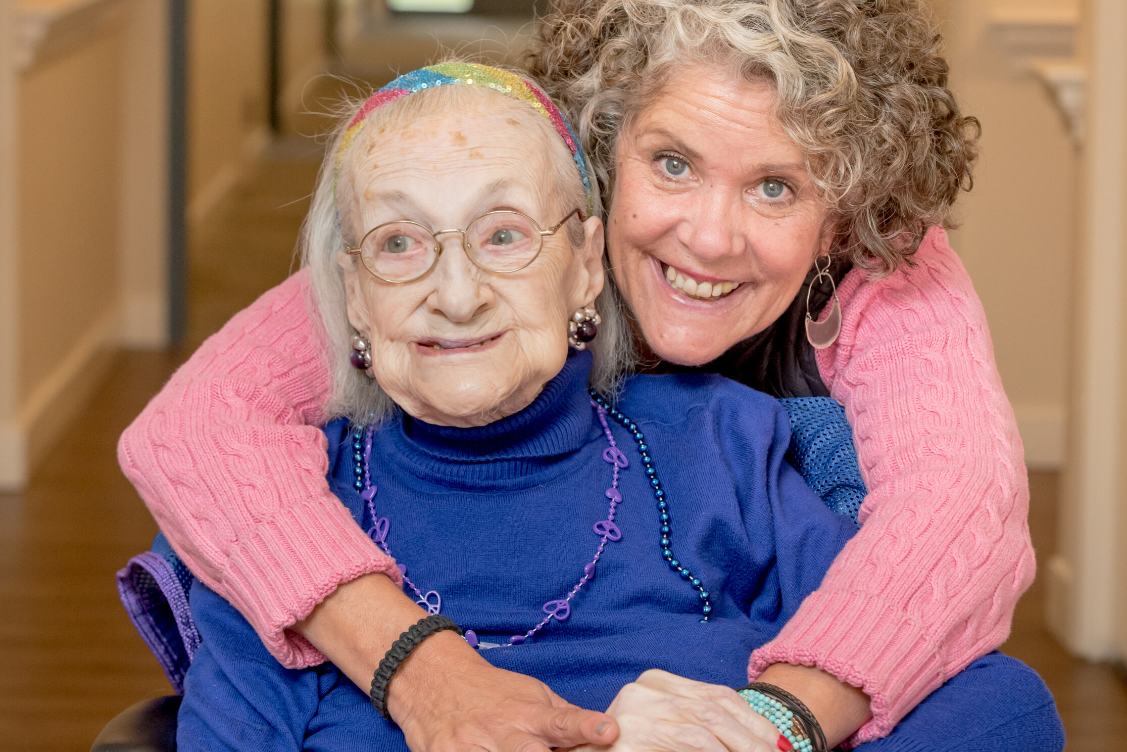 Photo of caregiver embracing memory care resident
