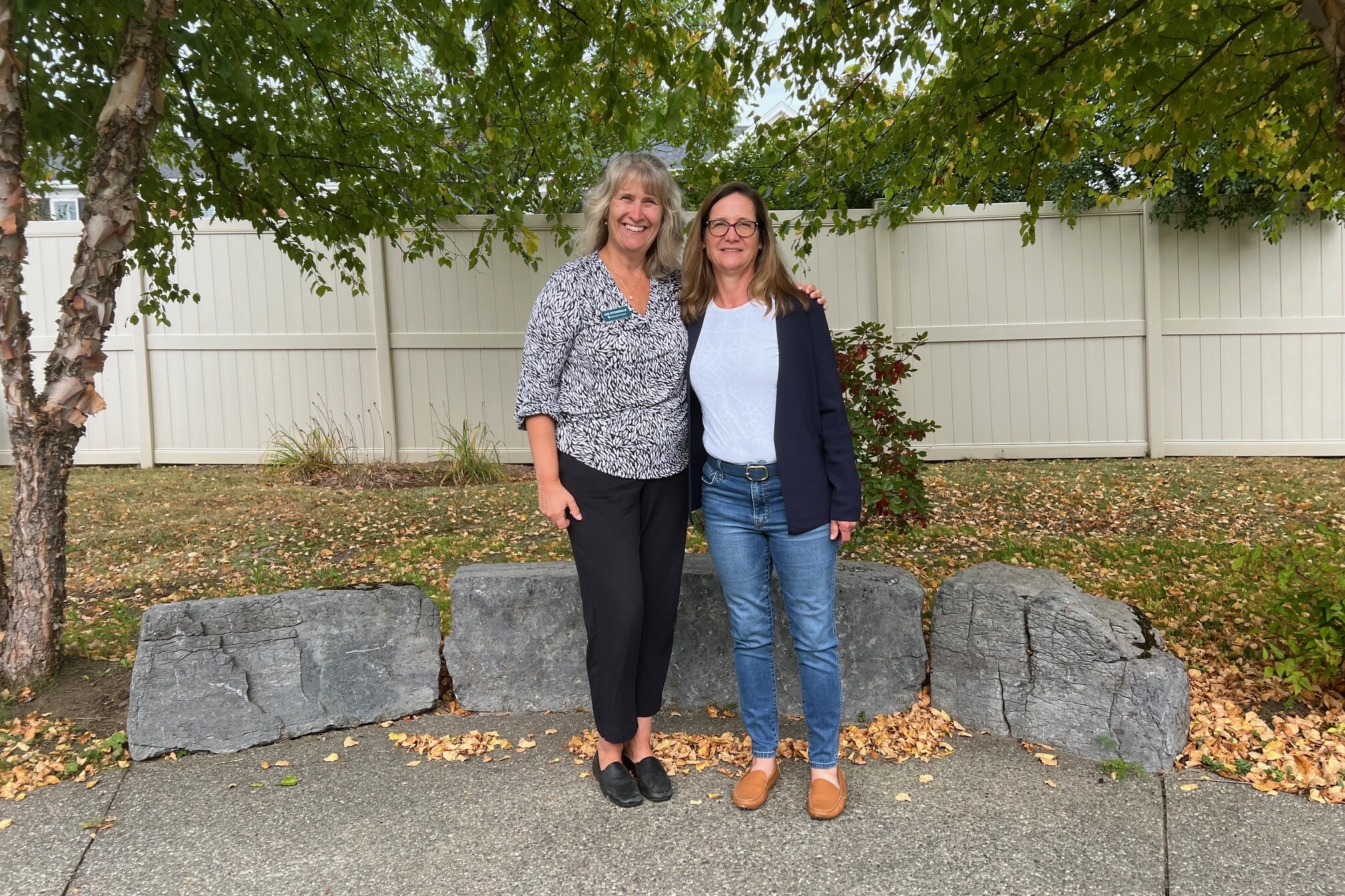 CEO Kim Fitzgerald and Miller family spokesperson Stephanie Miller Taylor in the garden at Memory Care at Allen Brook.