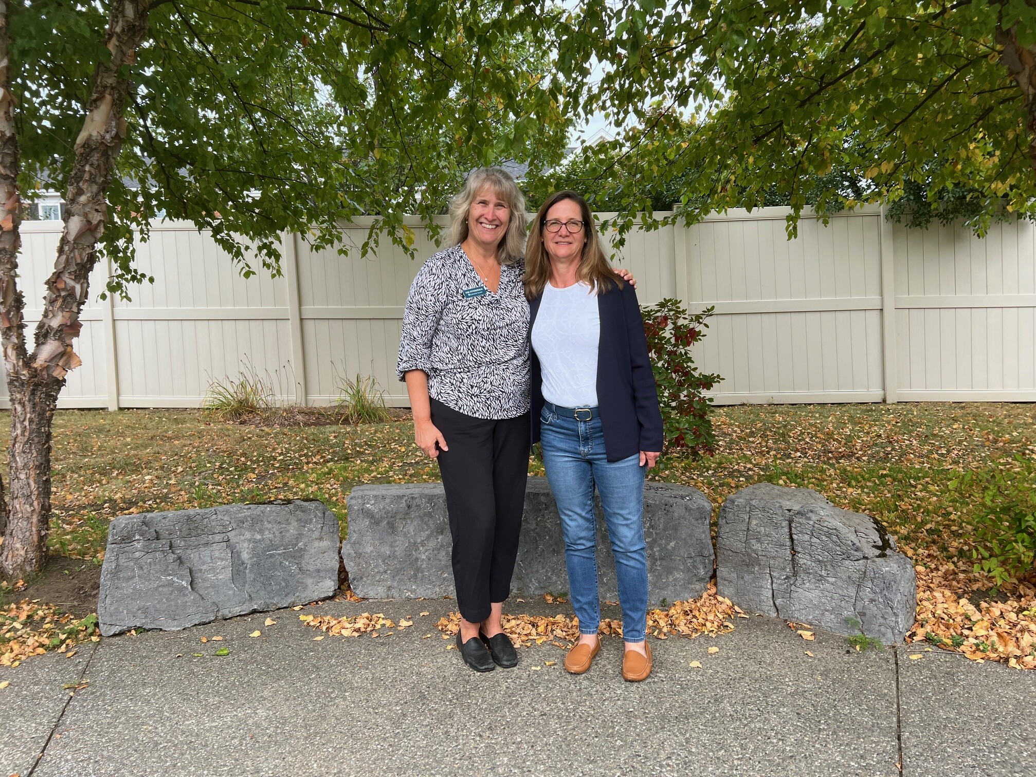 CEO Kim Fitzgerald and Miller family spokesperson Stephanie Miller Taylor in the garden at Memory Care at Allen Brook.