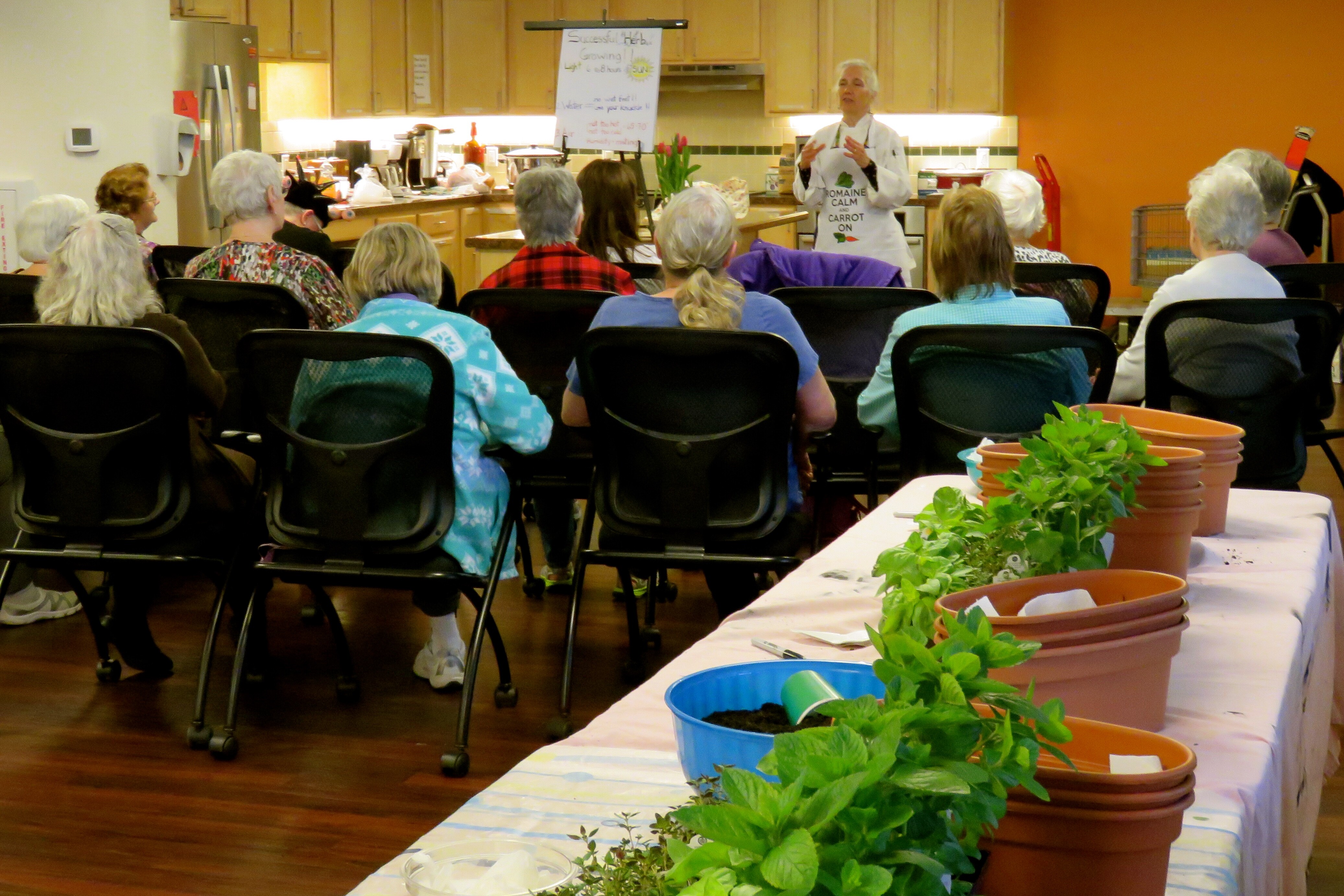 Chef Robin teaching a cooking class about herbs