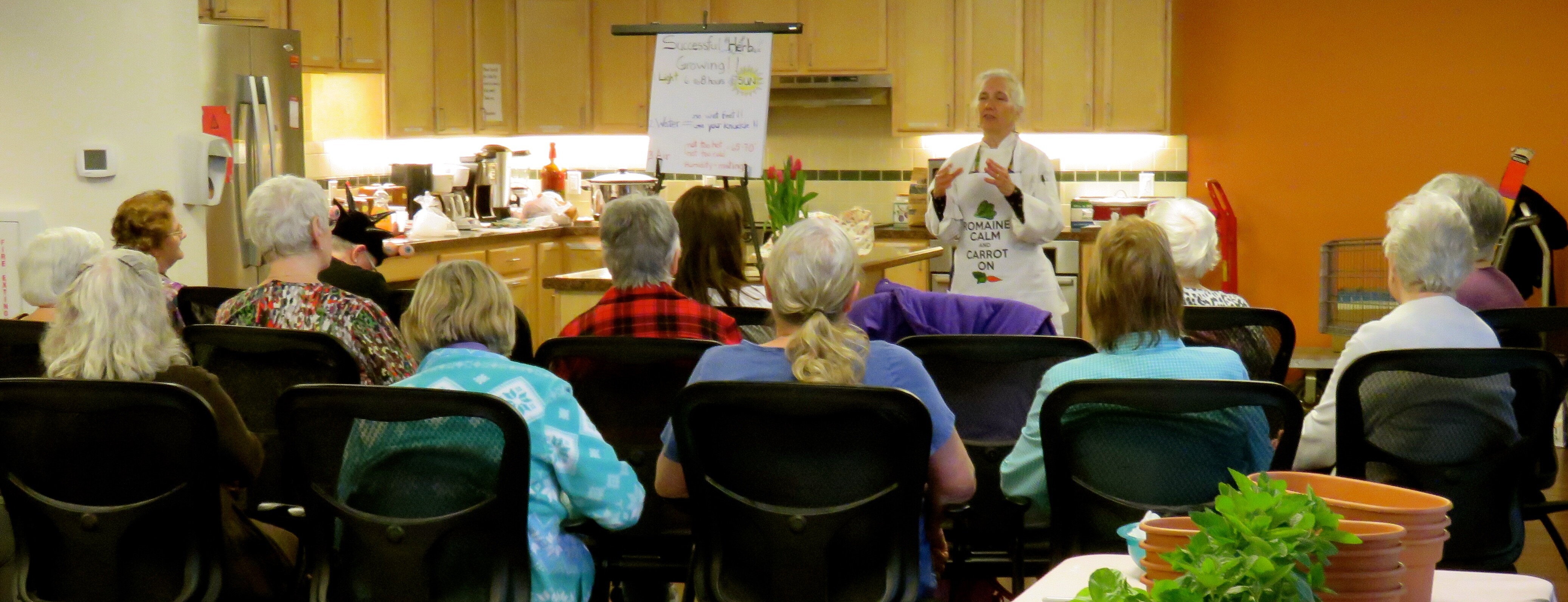 Chef Robin teaching a cooking class about herbs