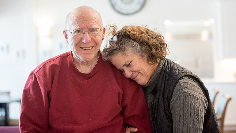 Allen Brook Activity Director Ellen Gagnon shares her affection with a resident.