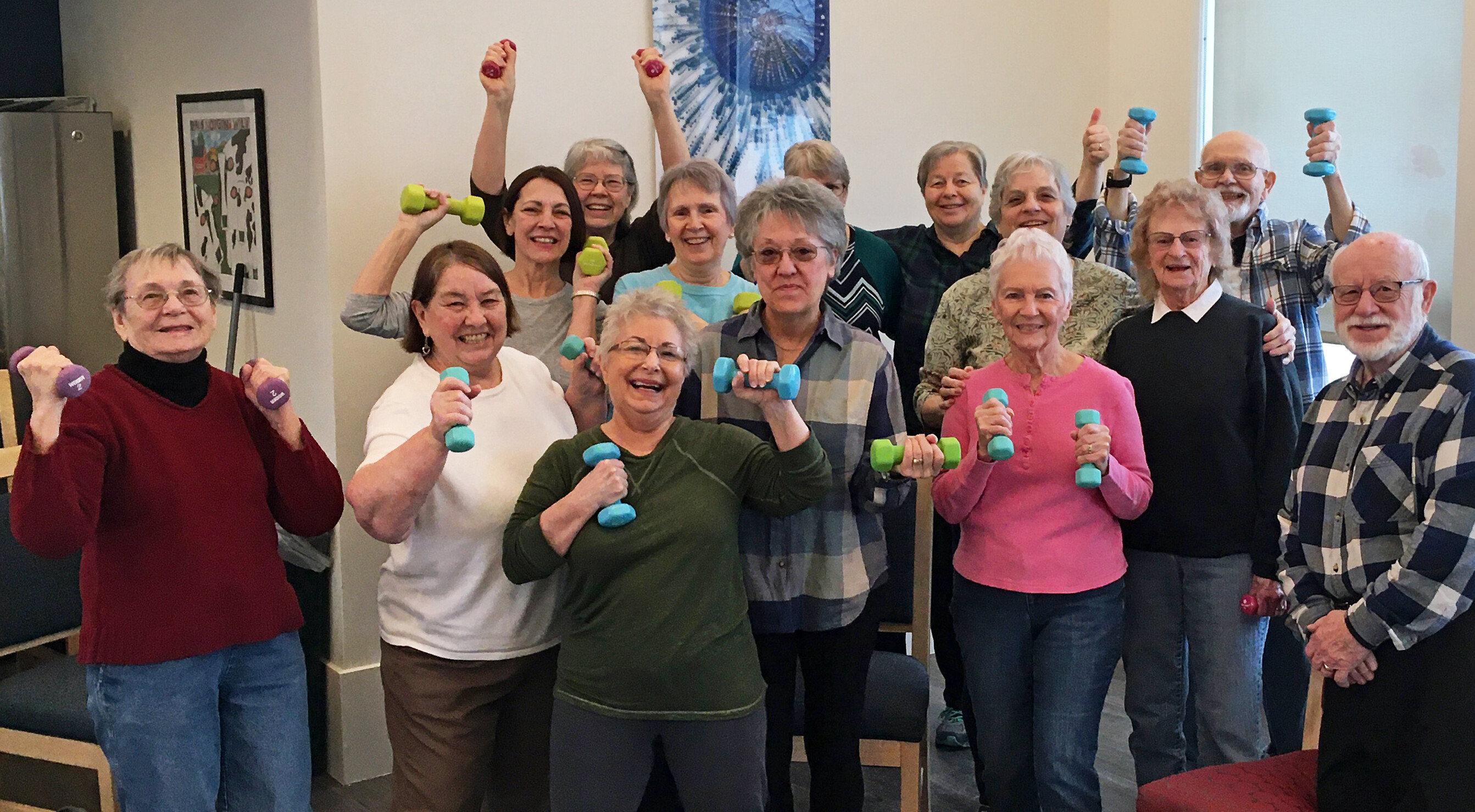 Residents at Elm Place in Milton are all smiles as they pose a group photo with their hand weights during their SASH-sponsored Bone Builders class.